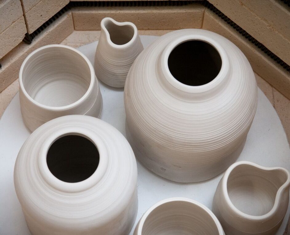 Children engaged in wheel throwing pottery at Nilis Art Studio in the Leander area during summer art camp.