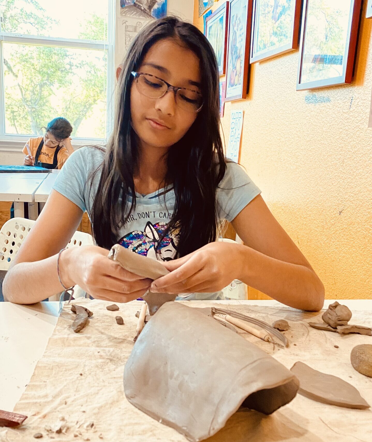 Children engaged in hand-building pottery during summer camp at Nilis Art Studio in North Austin.