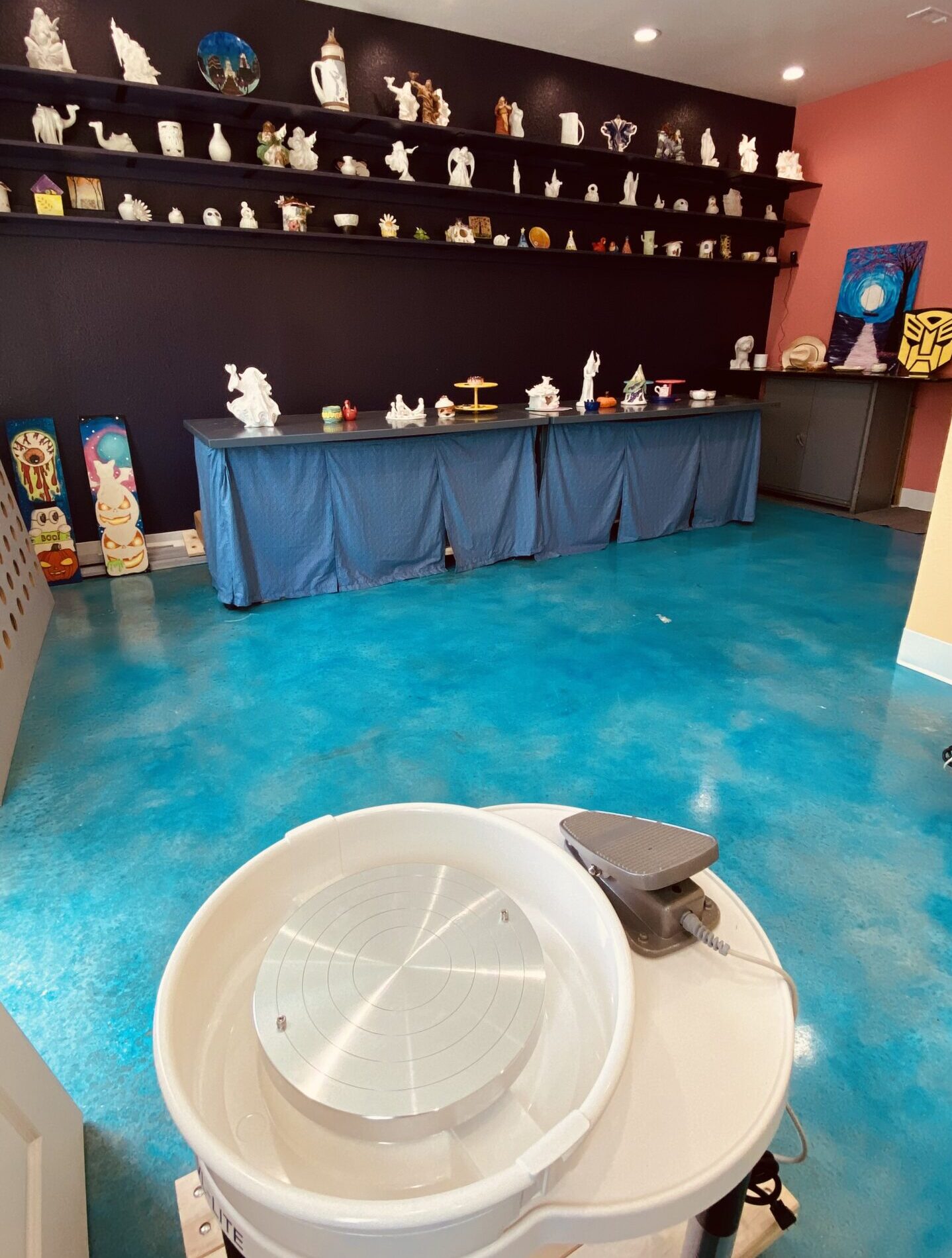 Children enjoying wheel throwing pottery techniques in a ceramic class at Nilis Art Studio near Round Rock.