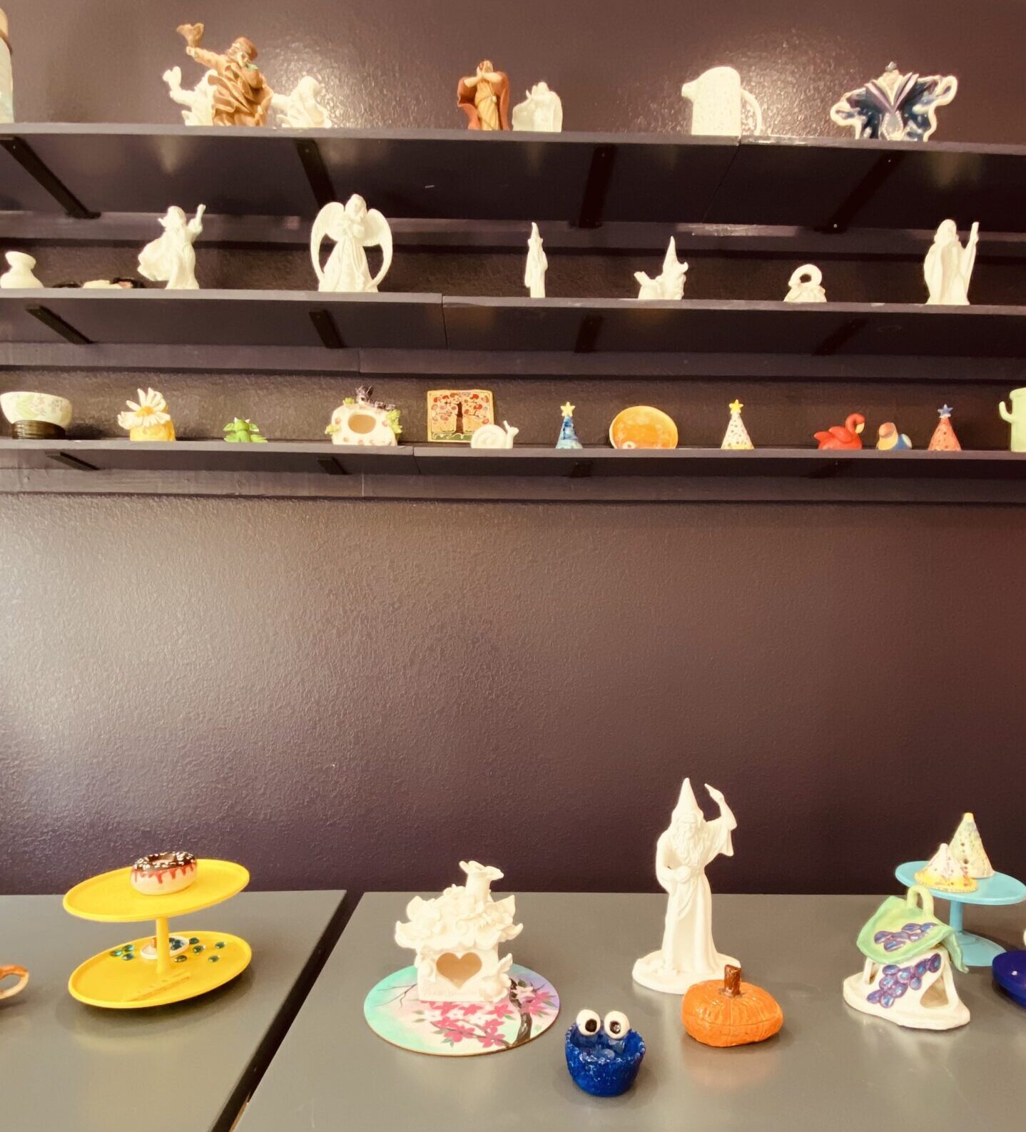 Children engaged in wheel throwing pottery at Nilis Art Studio in Cedar Park during summer art camp.